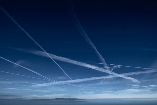 Blue Sky With Grid Of White Condensation Trails, Contrails, From Airplane