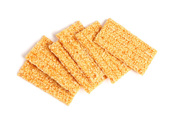 Tasty sesame kozinaki bars on white background