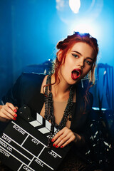 Young woman portrait with cinema clapper