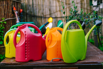 Colorful watering cans in the garden