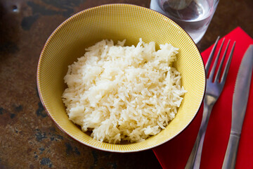 Cooked white rice in bowl closeup, food concept
