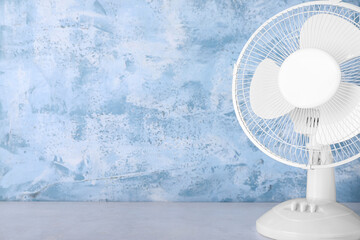 Electric fan on blue grunge background