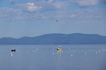 Parasailers and boaters begin their mornings on the peaceful waters of Lake Tahoe in the Sierra Nevada Mountains