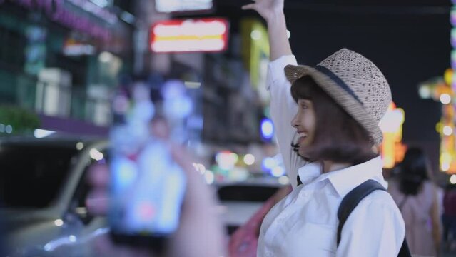 Tourism concept of 4k Resolution. Young female tourists taking pictures and playing in the city.