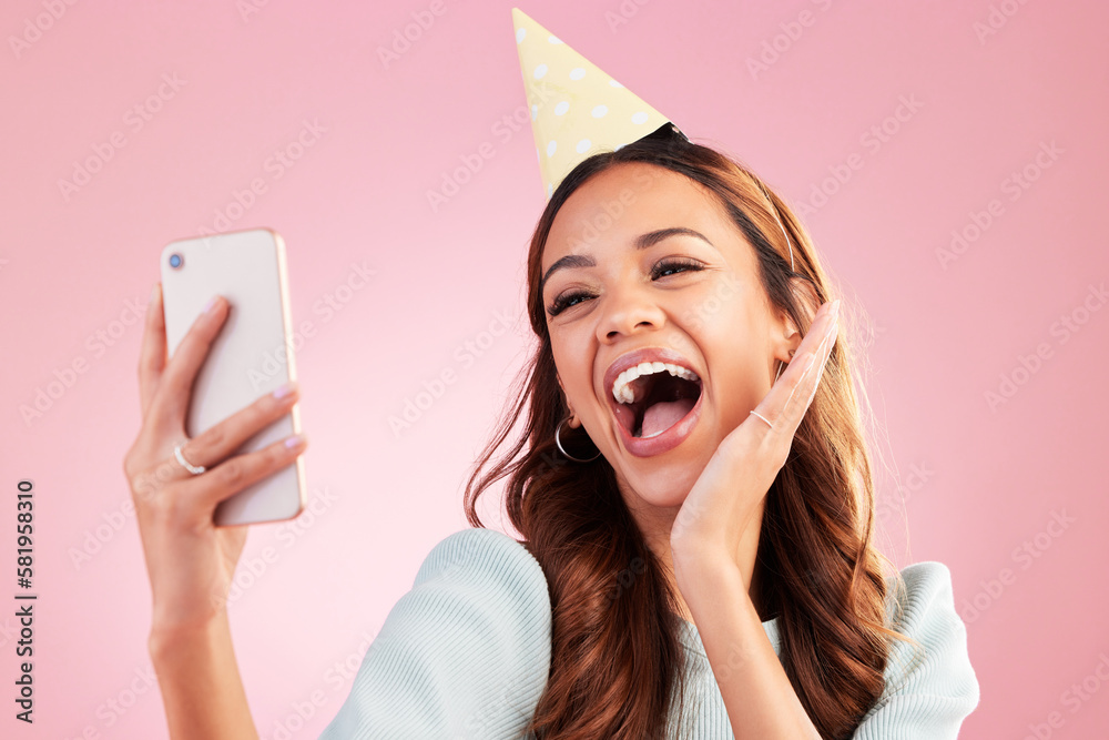 Sticker Birthday, selfie and excited with a woman in studio on a pink background for the celebration of an event. Phone, social media and party with an attractive young female celebrating a special occasion