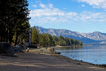 Parasailers and boaters begin their mornings on the peaceful waters of Lake Tahoe in the Sierra...