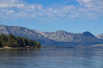 Parasailers and boaters begin their mornings on the peaceful waters of Lake Tahoe in the Sierra...