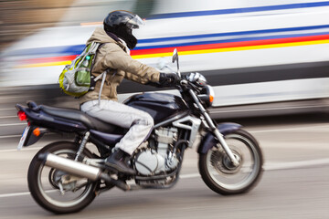 Fototapeta na wymiar motorcycle rider on a city street in motion blur