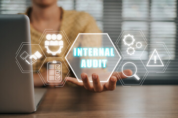 Internal audit concept, Person working on laptop computer and hand holding internal audit icon on...