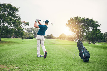 Golf, stroke and training with a sports man swinging a club on a field or course for recreation and fun. Golfing, grass and hobby with a male golfer playing a game on a green during summer
