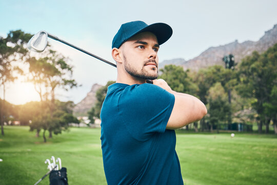 Golf, focus and hobby with a sports man swinging a club on a field or course for recreation and fun. Golfing, grass and stroke training with a male golfer playing a game on a green during summer