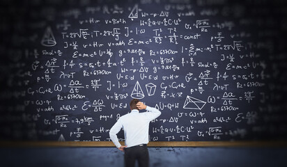 Businessman Thinks How to Solve Problem Concept with Blackboard with Math and Physics Formula and Equations. 