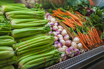 Lots of Vegetables in the Produce aisle at a Supermarket. Colorful counter with assortment of fresh vegetables for sale