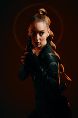 Woman, warrior and gun to fight in studio for action and safety from danger on dark background. Strong female model, assassin or agent in scifi cosplay costume with weapon for action and defense