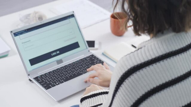 Woman trying wrong password over and over on laptop.
The woman enters the wrong password into the computer many times. The woman who forgot the password.
