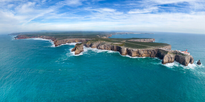 Panoramic aerial view of Farol do Cabo de Sao Vicente, a beautiful lighthouse on the cliff facing the Atlantic Ocean, Sagres, Algarve region, Portugal.