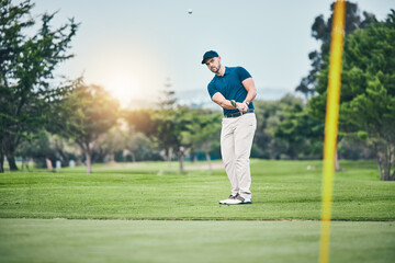 Golf, stroke and aim with a sports man swinging a club on a field or course for recreation, fun and hobby. Golfing, grass and training with a male golfer playing a game on a green during summer - obrazy, fototapety, plakaty