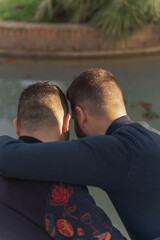 gay couple in the park, walking happily, loving and playful