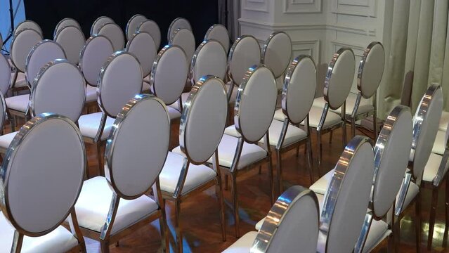 White transparent plastic Chiavari chairs in rows