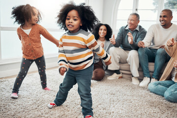 Big family, children dancing and living room with parents, grandparents or love with applause in...