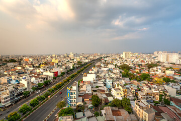 Saigon or Ho Chi Minh city skyline in sunset with colorful houses, Saigon is the largest city in...