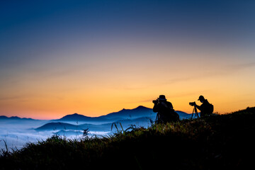 Fototapeta na wymiar Silhouettes of photographers while patiently waiting for dawn in the mountains of Da Lat, Lam Dong province, Vietnam