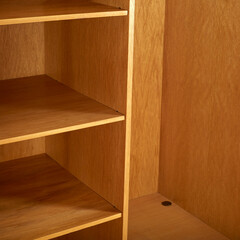 Fototapeta premium Vintage 1960s oak wood armoire. Mid-Century Modern furniture. Interior view of the shelves.