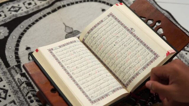 Hands open page Quran book