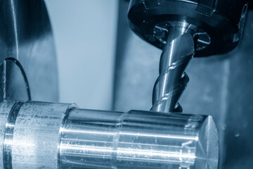 Close up scene the multi-tasking CNC lathe machine milling cut the metal shaft parts by milling...