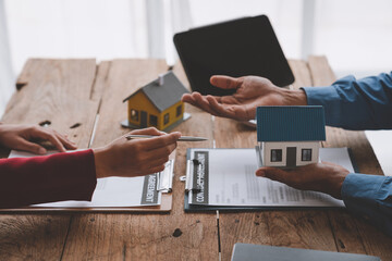 Businessman, insurance salesman explaining detailed information Components, structures, materials,...