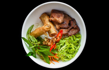 Traditional fried vietnamese spring rolls with pork served with rice noodles, fried pork and peanuts