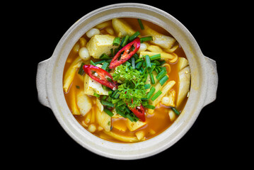 Vietnamese vegetairan soup with tofu, mushrooms and vegetables isolated on black background top view