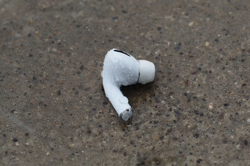 Wet wireless earphone in the Rain.