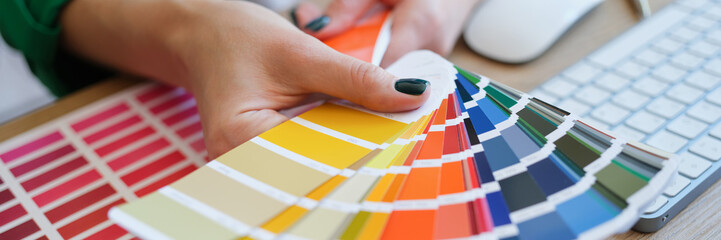 Graphic designer is working on choosing palette colors for creative business