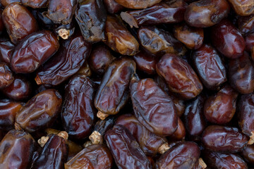 Dates (date palm fruits) displayed on the food market. Close up of dates on market stand. 