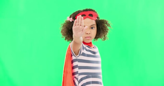 Child, superhero and hand on green screen to stop crime and fight with fantasy, dream or cosplay costume. Girl power, hero and pretend game with strong kid portrait to protect freedom of imagination