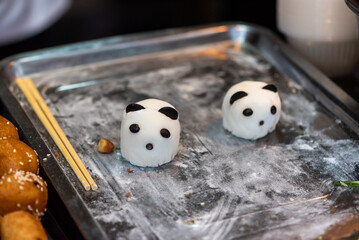 Panda shaped mantou Chinese steamed bun on a plate close-up view