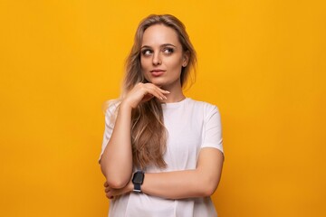 horizontal photo of a blond girl with empty space on a yellow background