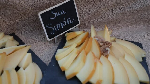 Degustation tray of san simon galician cheese with walnuts at outdoor event on black slate