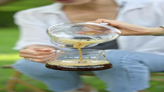 Person holding a glass of coffee