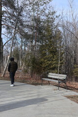 person walking by a bench