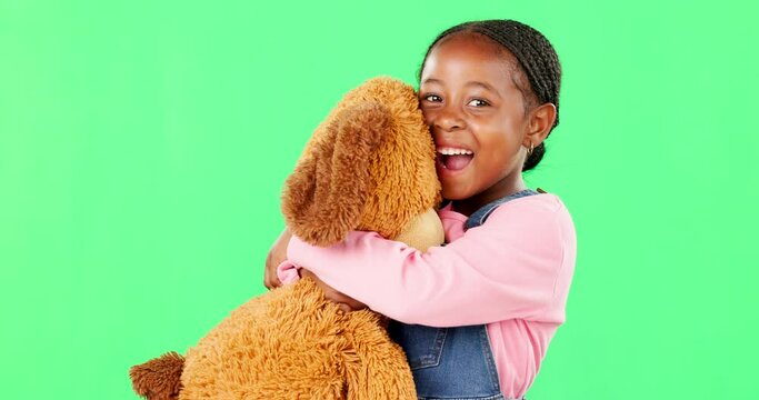 Green screen, love and a black girl hugging her teddy bear in studio in excitement or comfort. Portrait, happy and embrace with an adorable little female child holding her stuffed animal on chromakey