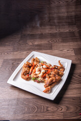 chinese and western mixed seafood combination cold platter with deep fried soft shell crab scallop salad on wood table asian banquet halal menu