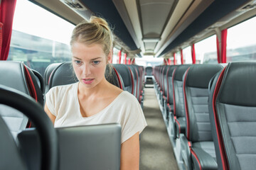 woman using her laptop inside a bus