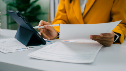 Close up hands of bookkeeper doing bookkeeping calculating audit, balance sheet and analyzing...