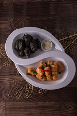 dou style deep fried crispy seafood beancurd black and white tofu in salted egg yolk sauce and mayonnaise sauce on wood table asian halal banquet appetiser snack salad menu 