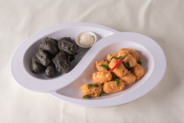 dou style deep fried crispy seafood beancurd black and white tofu in salted egg yolk sauce and mayonnaise sauce on wood table asian halal banquet appetiser snack salad menu 