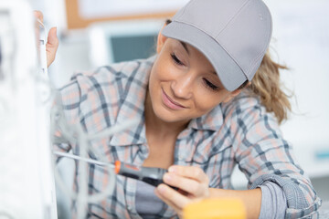woman using screwdriver on a device