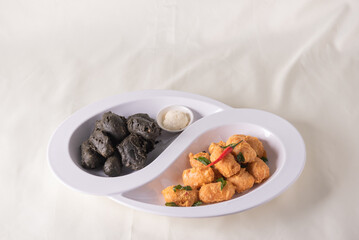 dou style deep fried crispy seafood beancurd black and white tofu in salted egg yolk sauce and mayonnaise sauce on wood table asian halal banquet appetiser snack salad menu 