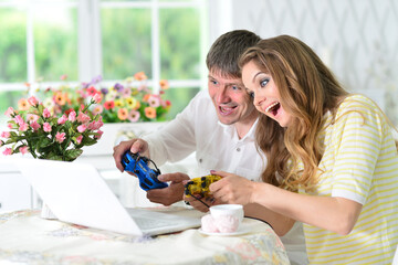 young couple at table and playing video game
